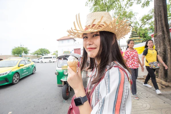 stock image Asian traveller woman walking on street food eat ice cream sunny day in Bangkok city Thailand