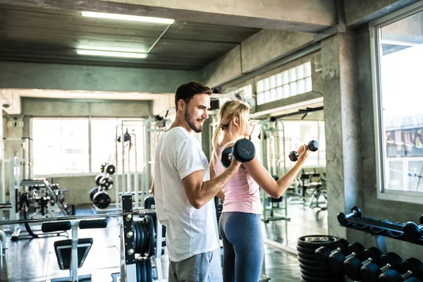 stock image Smart sport man and woman working out in fitness gym healthy lifestyle