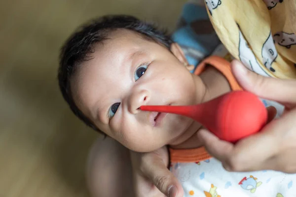 stock image Dad hand sucking mucus from 1 year infant boy noses newborn health care concept