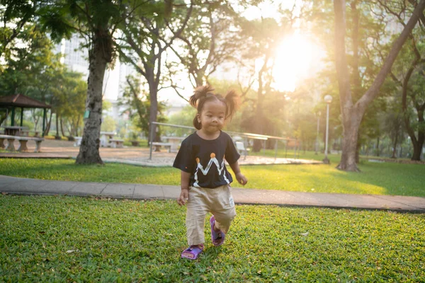 Adorable Little Asian Girl Walking Green Grass Public Park Morning — Stock Photo, Image