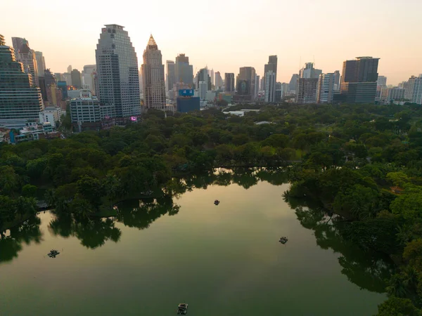 stock image Aerial view Lumpini central park with modern office building sunset sky downtown Bangkok Thailand