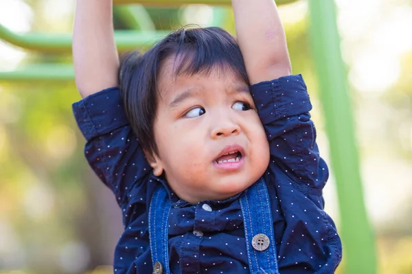 stock image Adorable asian 2 - 3 year boy climbing in playground outdoor city park