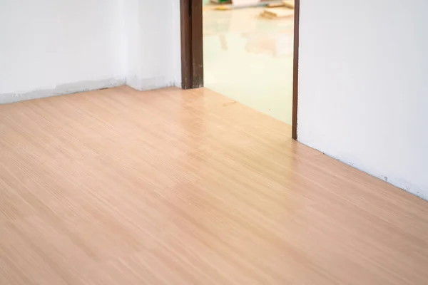 Light brown laminate floor in new modern room house interior building industry