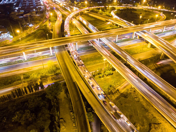 Aerial circular intersection transport city road at night with light vehicle movement