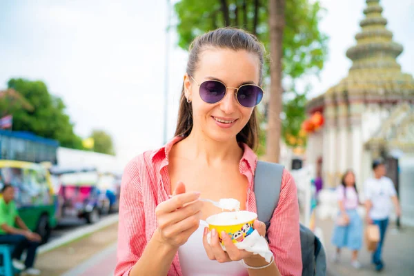 stock image Beautiful woman eat ice cream street food while travel in Bangkok Thailand