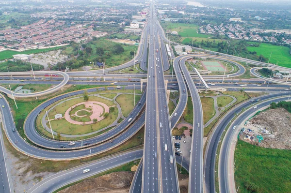 stock image City transport road with vehicle movement surround by village aerial view