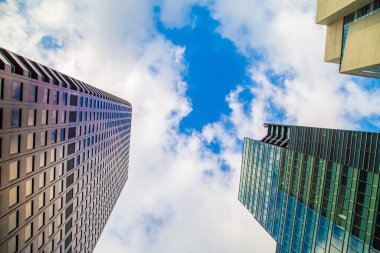 Window office building in Tokyo city against blue sky with cloud uprise view