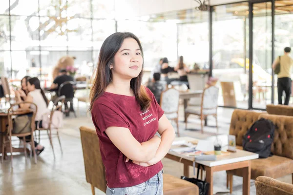 Beautiful asian woman ordering coffee in cafe