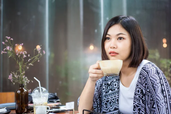 stock image Asian pretty woman drinking hot coffee in cafe