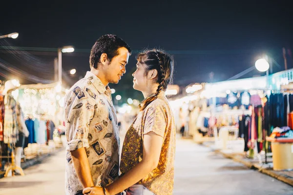 Couple in love at night market