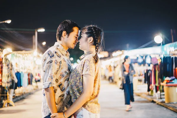 Couple in love at night market