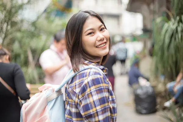 Beautiful asian woman backpacker travel in city street in Bangkok Thailad