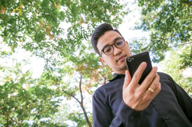 Yeşil park, iletişim iş kavramı cep telefonu konuşurken iş adamı