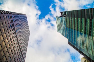 Window office building in Tokyo city against blue sky with cloud uprise view