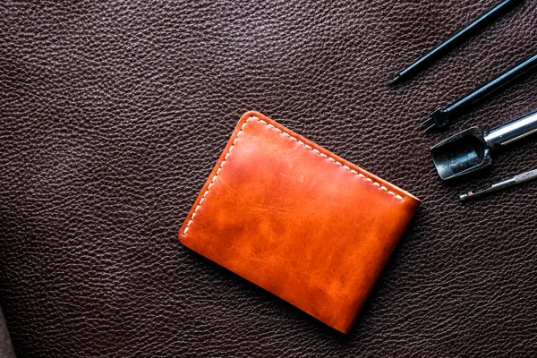 Tool making genuine leather wallet craftsmanship workshop flatlay on cowhide