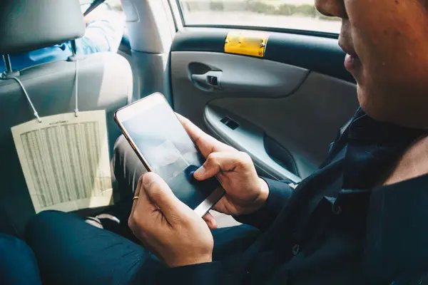 Business man hand use smartphone in car blank screen