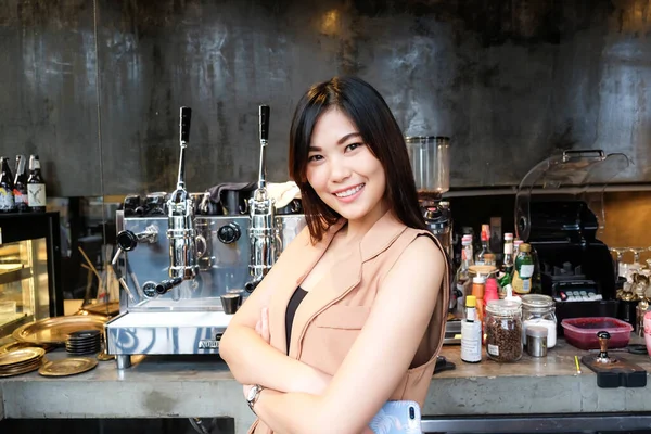 Barista women owner of coffee shop enterprise standing on counter
