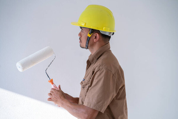 Interior painter man working on white new house room interior renovate design