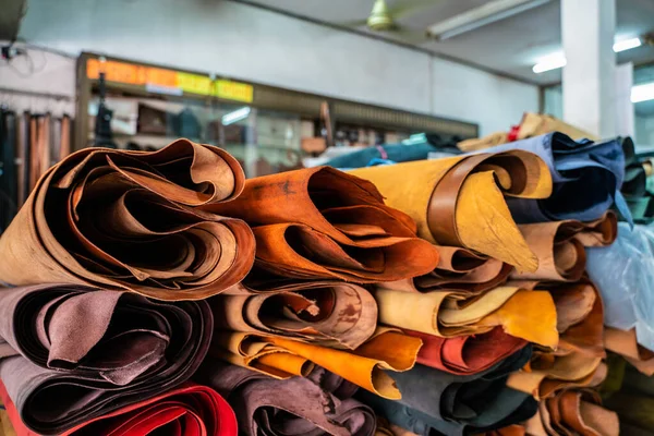 Colorful raw genuine vegetable tanned leather on shelf in crafts shop, Handmade market
