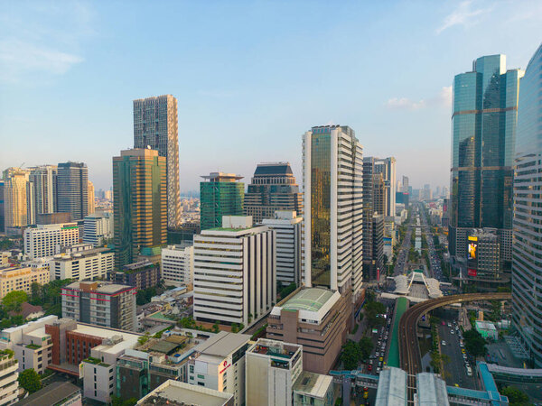 Aerial view city office building with BTS urban train transport sunset sky Silom district Bangkok Thailand