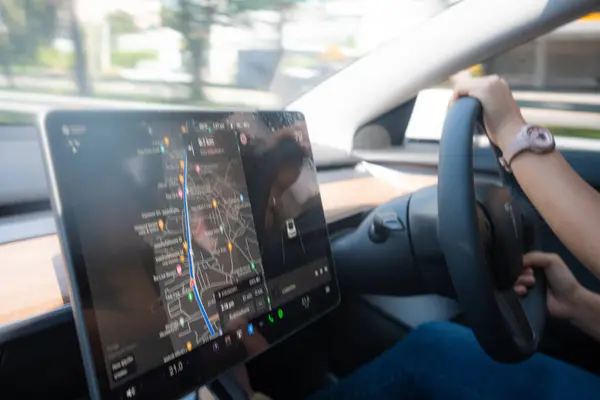Woman drive car use navigator GPS help on screen in car safty travel trip