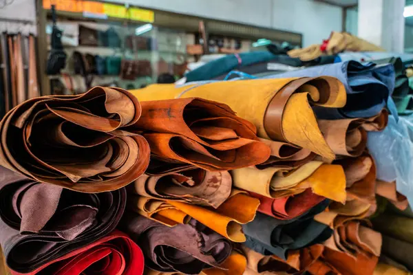 Colorful raw genuine vegetable tanned leather on shelf in crafts shop, Handmade market