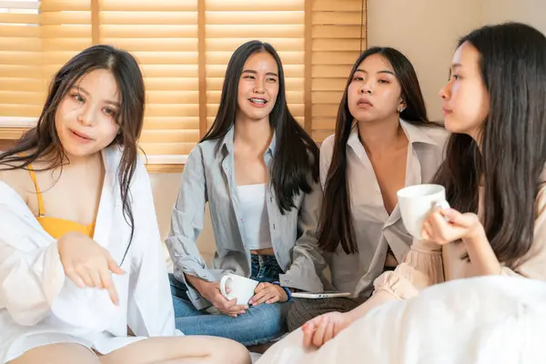 Beautiful asian business women group morning talk together and drink coff on bed, Friend group