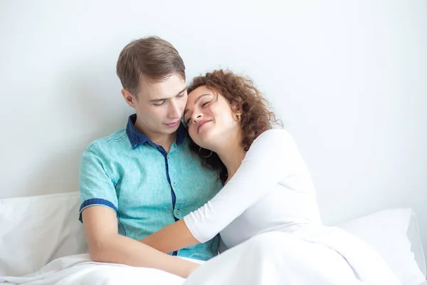 Love couple lying on white bed in morning happy and carring together relaxtion of love