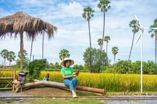 Modern farmer woman use tablet technology improve rice productivity in rice plantation field technology farmer