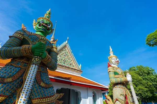 Statues of Giants in gate of temple demon guardians at Wat Arun. Famous temple in Bangkok, Thailand.