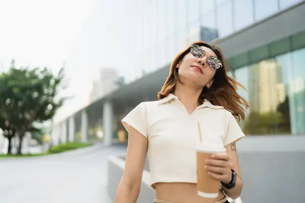 Smart business asian woman drink coffee use smartphone in city business office building outdoor recreation business woman