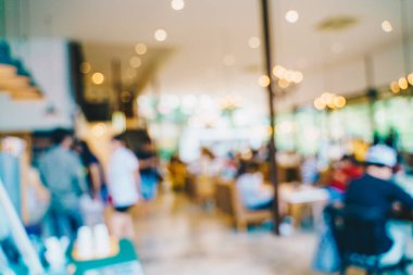 Kafenin arka planında bulanık şarap içen insanların olduğu soyut, bulanık bir kahve dükkanı.
