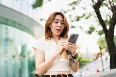 Business asian woman use smartphone internet connection in modern office city building casual business woman