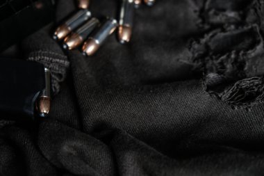 9mm conceal semi automatic gun with jacket hallow point bullet on cloth background