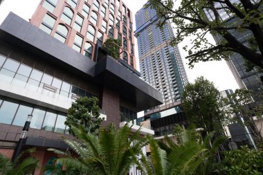 Modern ofis binası olan yeşil ağaç parkı Alacakaranlık Bangkok Tayland 'da yükseliş manzaralı
