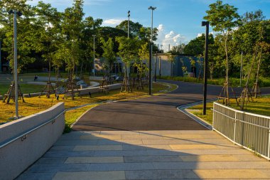 Şehir merkezindeki halk parkında asfalt yolda yürü ve koş.