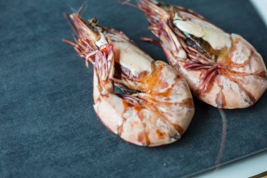 Prawn sea shrimp grilled on black plate top view