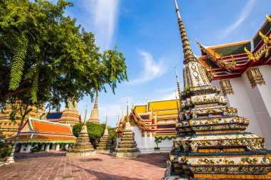 Beautiful pagoda of Wat Pho temple complex against blue sky sightseeing travel in Bangkok, Thailand