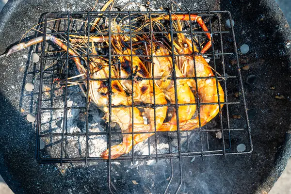 Büyük nehir karidesi ateşte kızartılmış deniz mahsulü yemeğiyle.