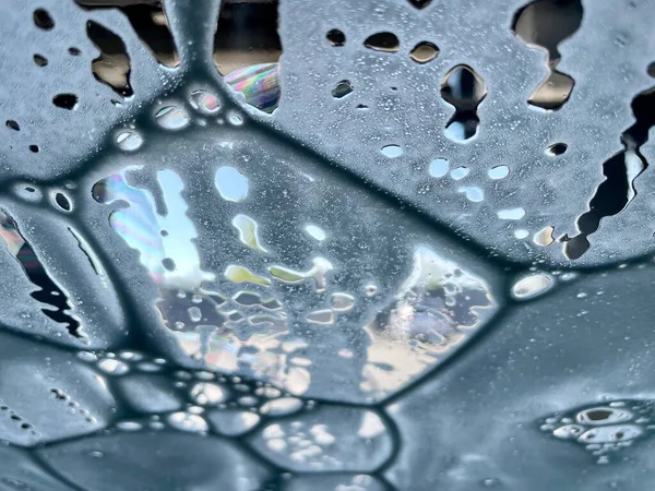 Soap bubbles on the glass. Soap foam texture.