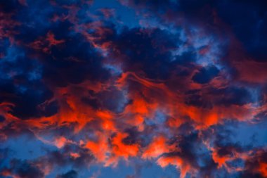 Red sunset clouds in the blue sky 