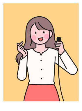 A woman taking a selfie with a camera switch in her hand. finger heart.