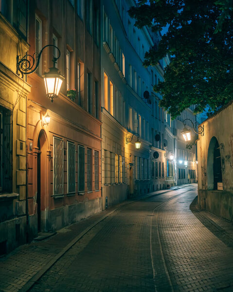A quiet cobblestone street at night in Warsaw, Poland