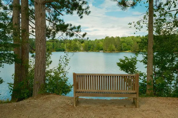 stock image A bench and Adirondack Lake, Indian Lake, New York