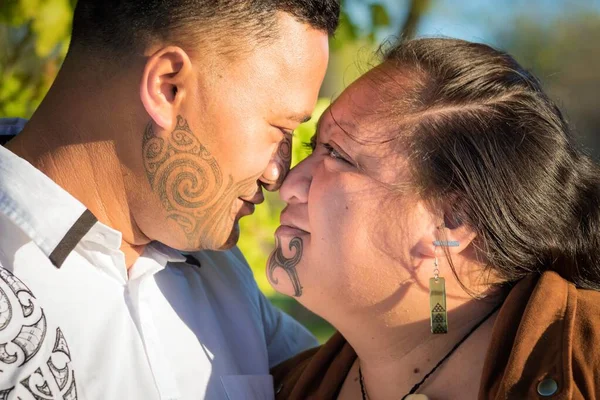 stock image Portrait of an attractive young Maori couple staring into each others eyes taken outdoors