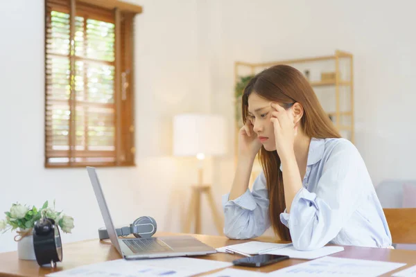 stock image Remote business concept, Businesswoman stress and headache while thinking marketing plan of startup.