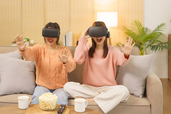 stock image Friendship concept, LGBT lesbian couple playing game and touching air in virtual reality experience.