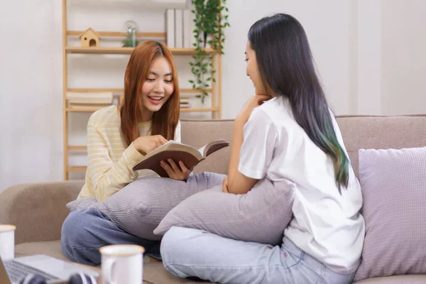 stock image Activity at home concept, LGBT lesbian female is reading holy bible to girlfriend in living room.