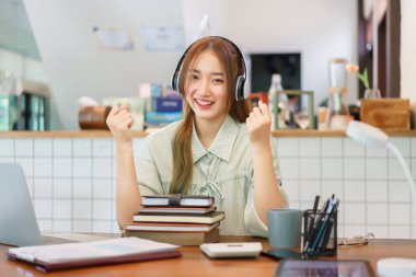 Coworking space office concept, Woman entrepreneur raise arms to celebrate after completing meeting.