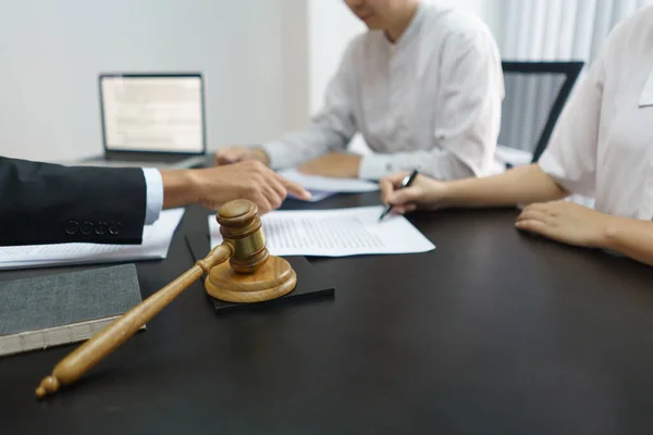 stock image Lawyer and justice concept, Couple signing divorce contract after senior lawyer explains details.